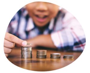 Child stacking coins to represent childcare tuition rates and center revenue planning